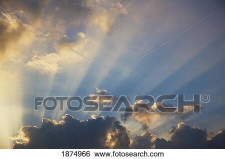 Stock Photograph - rays of light shining through clouds. Fotosearch