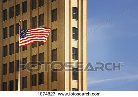 san antonio, texas, united states of america; an american flag in front of a building View Large Photo Image Stock Photo - san antonio, texas, united states of america; an american flag in front of a building. Fotosearch