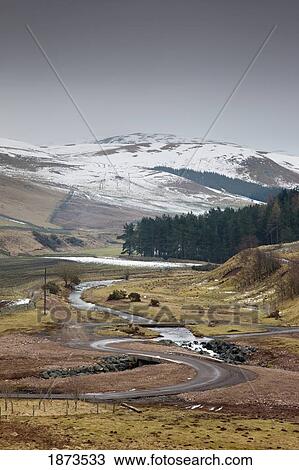 scottish borders, scotland; a road winding through fields and snow covered mountains View Large Photo Image Stock Image - scottish borders, scotland; a road winding through fields and snow covered mountains. Fotosearch