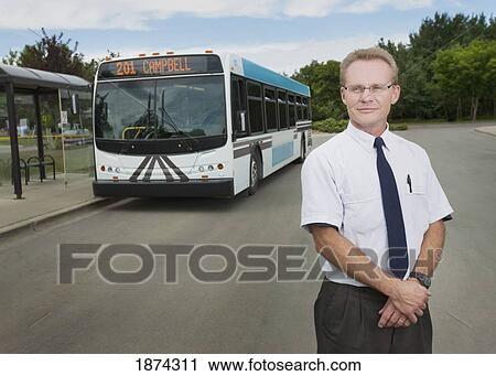 Stock Image - st. albert, alberta, canada; a bus driver with a city bus in the background. Fotosearch