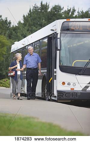 st. albert, alberta, canada; a man and woman walking to get on a city bus View Large Photo Image Stock Image - st. albert, alberta, canada; a man and woman walking to get on a city bus. Fotosearch