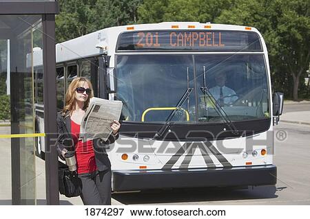 st. albert, alberta, canada; a woman waits at a bus stop as the bus approaches View Large Photo Image Stock Photo - st. albert, alberta, canada; a woman waits at a bus stop as the bus approaches. Fotosearch