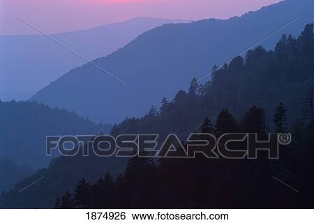 Stock Photograph - tennessee, united states of america; sunset light filtering through misty mountain ridges at the great smoky mountains national park. Fotosearch