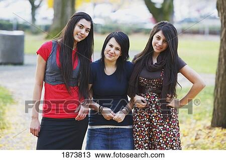 three teenage girls standing together in a park in autumn View Large Photo Image Stock Image - three teenage girls standing together in a park in autumn. Fotosearch