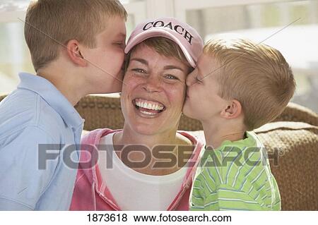 two sons kissing their mother's cheeks View Large Photo Image Stock Photo - two sons kissing their mother's cheeks. Fotosearch