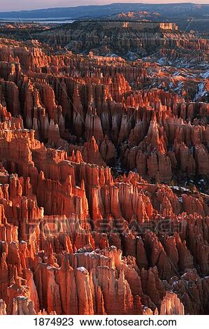 Stock Image - utah, united states of america; sandstone hoodoos of bryce amphitheater viewed from inspiration point at sunrise in winter in bryce canyon national park. Fotosearch