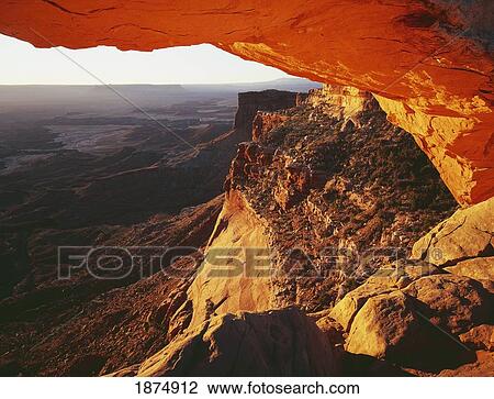 Stock Image - utah, united states of america; sunrise view of monument valley through mesa arch in canyonlands national park, island in the sky district. Fotosearch