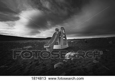Stock Image - victoria island, northwest territories, canada; an abandoned child's slide on the beach. Fotosearch