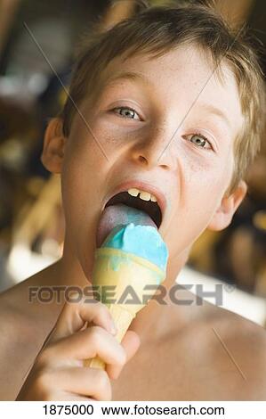 Stock Image - willmar, minnesota, united states of america; a boy eating an ice cream cone. Fotosearch