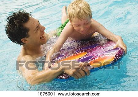 willmar, minnesota, united states of america; brothers playing together in the swimming pool View Large Photo Image Stock Image - willmar, minnesota, united states of america; brothers playing together in the swimming pool. Fotosearch