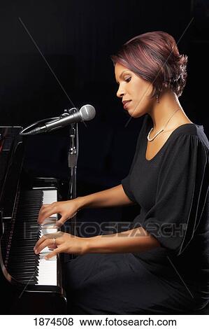 Woman playing piano View Large Photo Image Stock Photo - Woman playing piano. Fotosearch