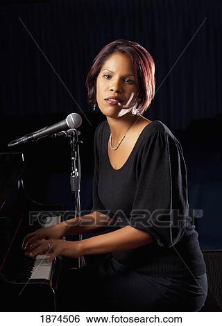 Woman with microphone View Large Photo Image Stock Photograph - Woman with microphone. Fotosearch