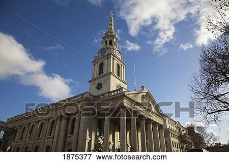 Stock Photo - a building with columns, a clock tower and a spire. Fotosearch