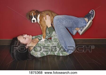 a girl holding her pet dog View Large Photo Image Stock Photo - a girl holding her pet dog. Fotosearch