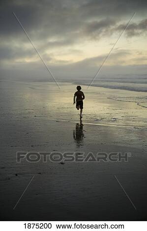 a person running on the beach at sunset View Large Photo Image Stock Image - a person running on the beach at sunset. Fotosearch