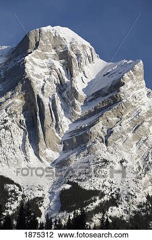 alberta, canada; snow covered mountain with dramatic fault lines in kananaskis country View Large Photo Image Stock Image - alberta, canada; snow covered mountain with dramatic fault lines in kananaskis country. Fotosearch