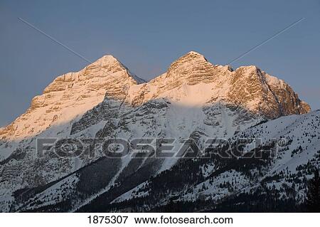 alberta, canada; snow covered mountain peaks at sunrise in kananaskis country View Large Photo Image Stock Photo - alberta, canada; snow covered mountain peaks at sunrise in kananaskis country. Fotosearch