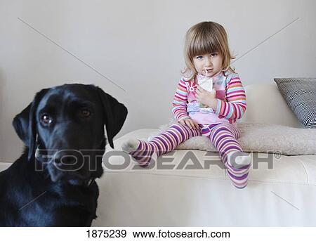 cadiz, spain; a young girl enjoys a juice box while sitting beside her pet dog View Large Photo Image Stock Photo - cadiz, spain; a young girl enjoys a juice box while sitting beside her pet dog. Fotosearch