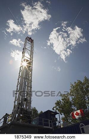 calgary, alberta, canada; a drilling rig with a sunburst View Large Photo Image Stock Photo - calgary, alberta, canada; a drilling rig with a sunburst. Fotosearch