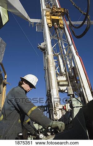 edson, alberta, canada; drilling rig worker working on the control panel on rig platform View Large Photo Image Stock Image - edson, alberta, canada; drilling rig worker working on the control panel on rig platform. Fotosearch