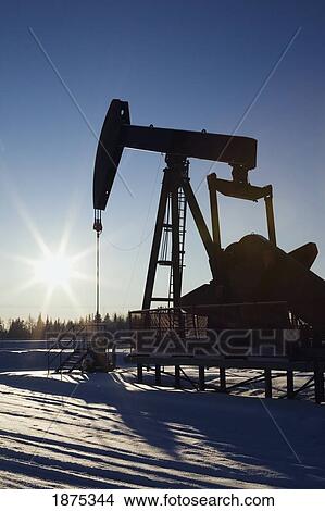 edson, alberta, canada; silhouette of a pump jack with a sunburst in winter View Large Photo Image Picture - edson, alberta, canada; silhouette of a pump jack with a sunburst in winter. Fotosearch