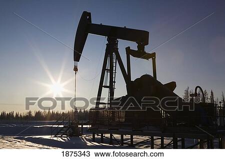 edson, alberta, canada; silhouette of a pump jack with a sunburst in winter View Large Photo Image Stock Image - edson, alberta, canada; silhouette of a pump jack with a sunburst in winter. Fotosearch