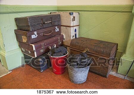 grosmount station, north yorkshire, england; suitcases and a trunk piled in the corner with buckets of coal at the railway station View Large Photo Image Stock Photo - grosmount station, north yorkshire, england; suitcases and a trunk piled in the corner with buckets of coal at the railway station. Fotosearch