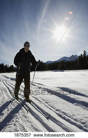 lake louise, alberta, canada; cross country skier on a trail with a sunburst View Large Photo Image Stock Photo - lake louise, alberta, canada; cross country skier on a trail with a sunburst. Fotosearch