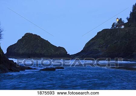 Stock Image - oregon, united states of america; heceta head lighthouse at morning light along the coast of the pacific ocean. Fotosearch