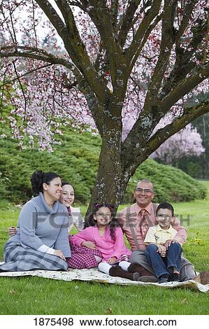 Stock Photo - portland, oregon, united states of america; family sitting under a cherry blossom tree. Fotosearch
