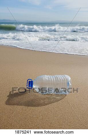 Stock Image - tarifa, costa de la luz, cadiz, andalusia, spain; an empty plastic water bottle on bunker beach. Fotosearch