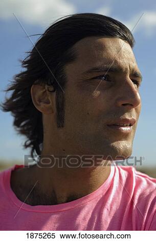 Stock Photography - tarifa, costa de la luz, cadiz, andalucia, spain; a man with his hair blowing in the wind. Fotosearch