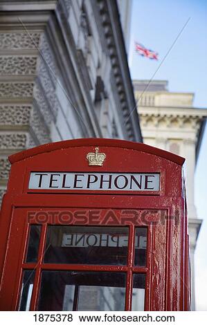 united kingdom; a red telephone booth with the union jack flag flying in the background View Large Photo Image Stock Photo - united kingdom; a red telephone booth with the union jack flag flying in the background. Fotosearch