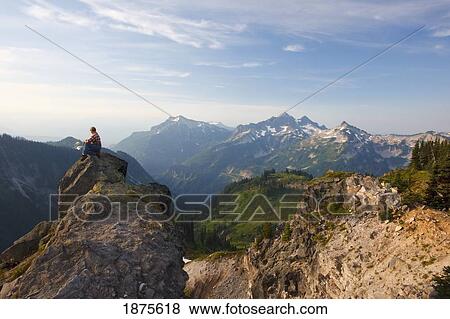 washington, united states of america; a man sitting on a rock overlooking the tatoosh mountains in paradise park in mt. rainier national park View Large Photo Image Stock Photo - washington, united states of america; a man sitting on a rock overlooking the tatoosh mountains in paradise park in mt. rainier national park. Fotosearch