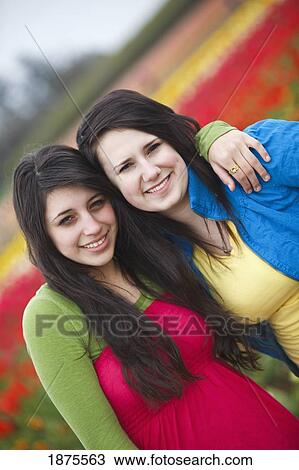 Stock Image - woodburn, oregon, united states of america; two teenage girls at the wooden shoe tulip farm. Fotosearch
