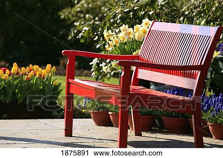 Stock Image - A Red Park Bench In The Sun. Fotosearch