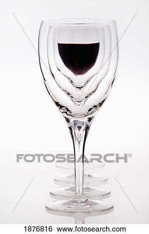 Stock Photograph - A Row Of Wine Glasses With Red Wine In The Last Glass. Fotosearch