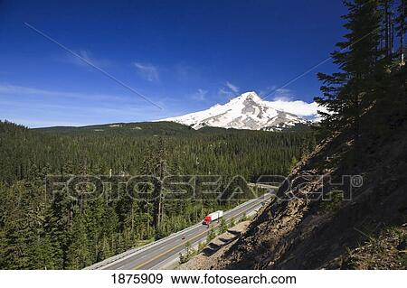 Stock Photo - A Transport Truck On The Highway Traveling Through The Mountains. Fotosearch