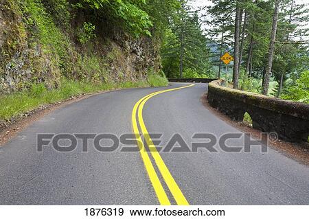 A Winding Road Surrounded By A Rock Cliff And Forest View Large Photo Image Stock Photo - A Winding Road Surrounded By A Rock Cliff And Forest. Fotosearch