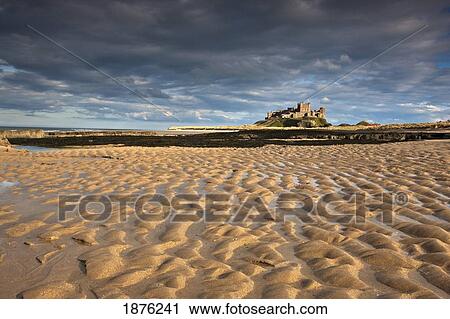 Stock Image - Bamburgh, Northumberland, England; View Of Bamburgh Castle From A Sandy Beach. Fotosearch