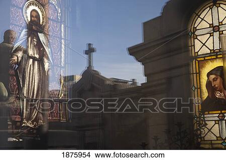 Buenos Aires, Argentina; A Stained Glass Window Depicting Jesus With A Reflection Of A Cross In Recoleta Cemetery View Large Photo Image Picture - Buenos Aires, Argentina; A Stained Glass Window Depicting Jesus With A Reflection Of A Cross In Recoleta Cemetery. Fotosearch