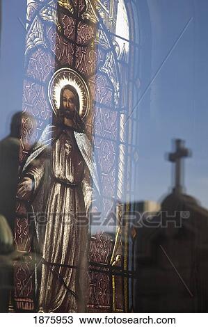 Buenos Aires, Argentina; A Stained Glass Window Depicting Jesus With A Reflection Of A Cross In Recoleta Cemetery View Large Photo Image Stock Image - Buenos Aires, Argentina; A Stained Glass Window Depicting Jesus With A Reflection Of A Cross In Recoleta Cemetery. Fotosearch