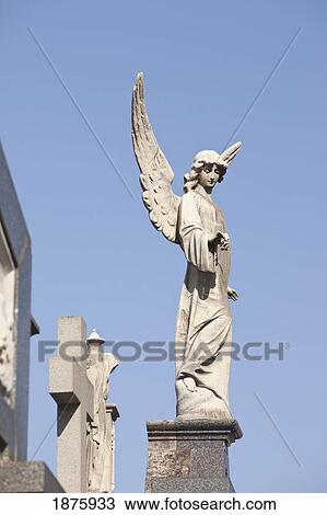 Buenos Aires, Argentina; Angel Statues And A Cross Made Of Stone On Top Of Tombs In The Recoleta Cemetery View Large Photo Image Stock Image - Buenos Aires, Argentina; Angel Statues And A Cross Made Of Stone On Top Of Tombs In The Recoleta Cemetery. Fotosearch