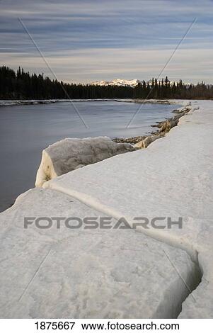Cochrane, Alberta, Canada; The Bow River In Winter With The Rocky Mountains In The Distance View Large Photo Image Stock Photo - Cochrane, Alberta, Canada; The Bow River In Winter With The Rocky Mountains In The Distance. Fotosearch