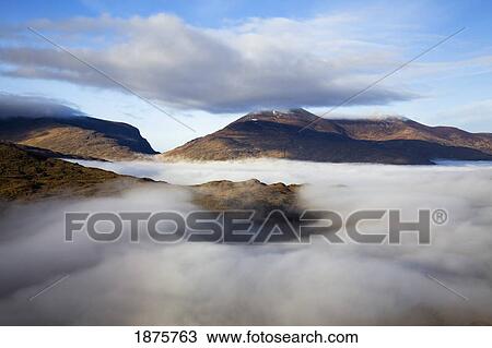 Stock Image - County Kerry, Ireland; Fog In The Valley At Molls Gap Near Killarney. Fotosearch
