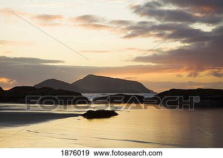 Derrynane Beach, County Kerry, Ireland; A View Of The Water From The Coast At Sunset View Large Photo Image Stock Photo - Derrynane Beach, County Kerry, Ireland; A View Of The Water From The Coast At Sunset. Fotosearch