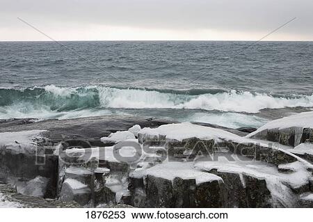 Grand Marais, Minnesota, United States Of America; Waves Crashing Against Ice Covered Rocks In Winter View Large Photo Image Stock Image - Grand Marais, Minnesota, United States Of America; Waves Crashing Against Ice Covered Rocks In Winter. Fotosearch