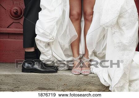 Stock Photo - Hamilton, Ontario, Canada; The Feet Of A Bride And Groom. Fotosearch