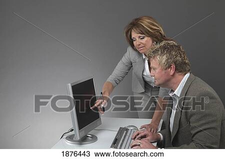 Stock Image - Jordan, Ontario, Canada; A Man And Woman Working At A Computer. Fotosearch