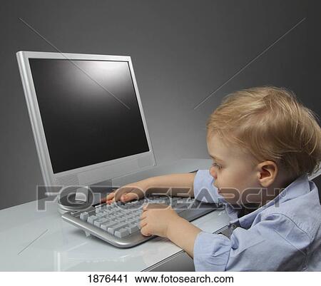 Stock Image - Jordan, Ontario, Canada; A Toddler Typing At A Computer. Fotosearch